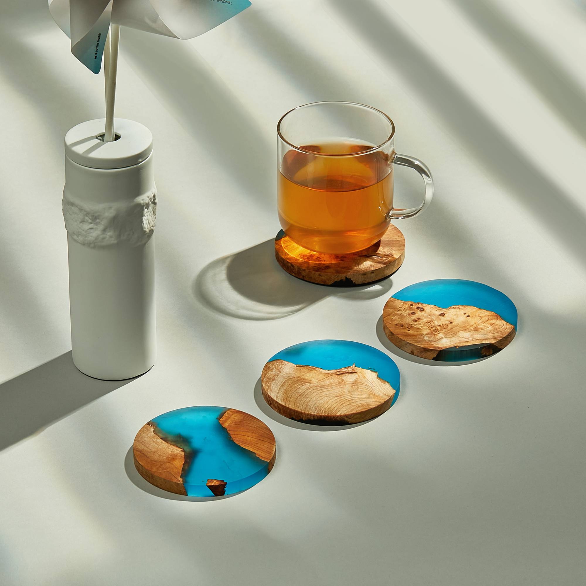 Epoxy resin wooden coasters set used under drinks on a bar table