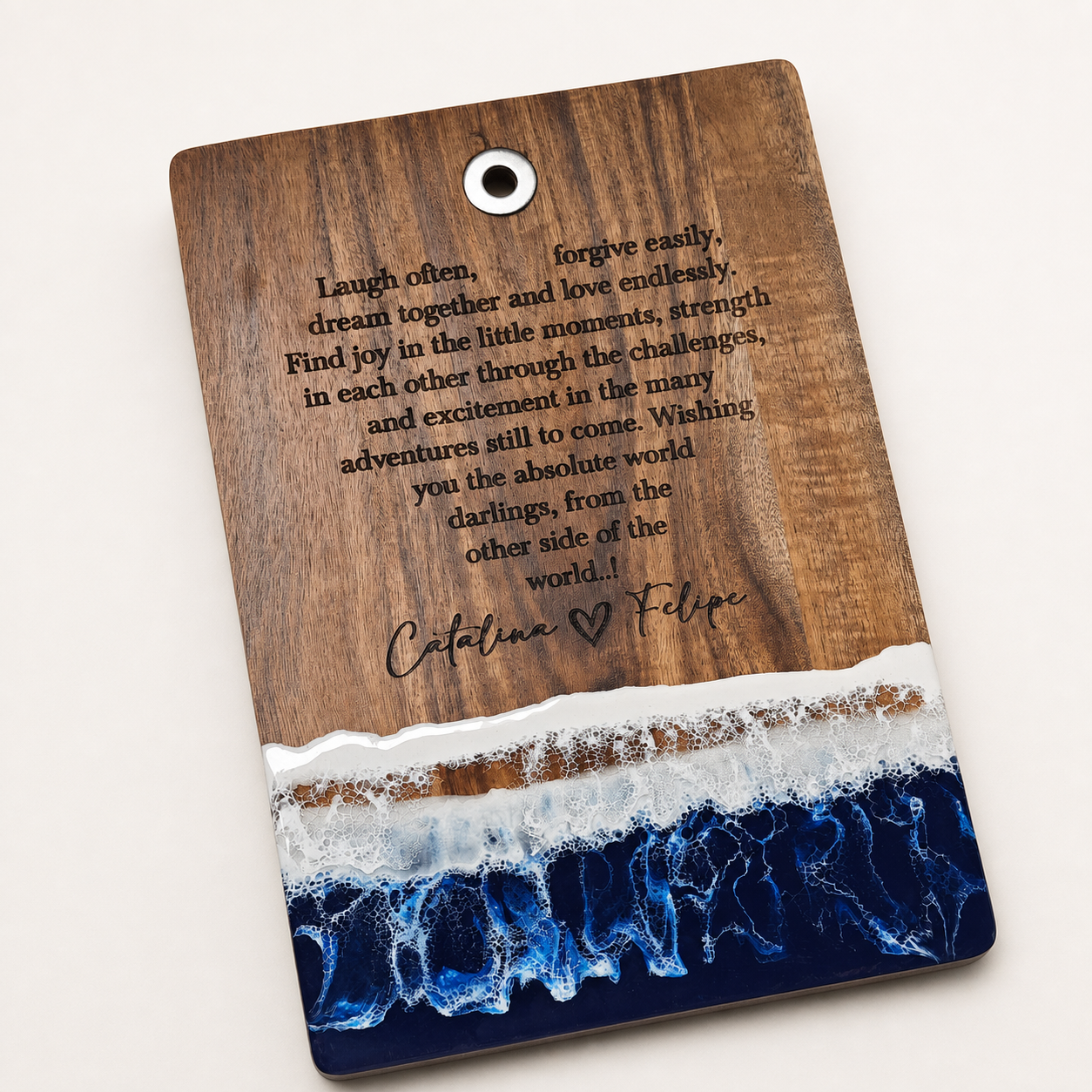 Personalized anniversary cutting board with a heart-arranged message and two engraved names